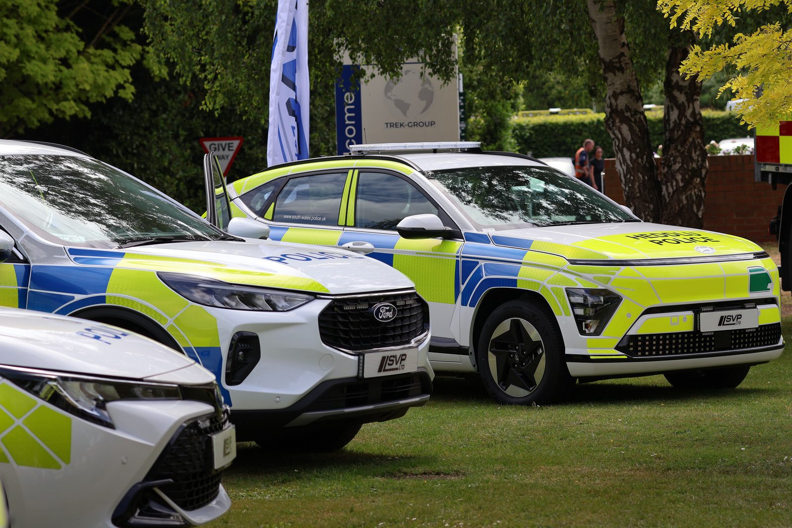 Police vehicles with Trek Group signage
