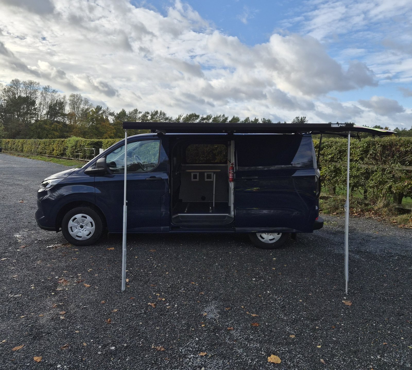 Police Examiner van, side view with awning extended