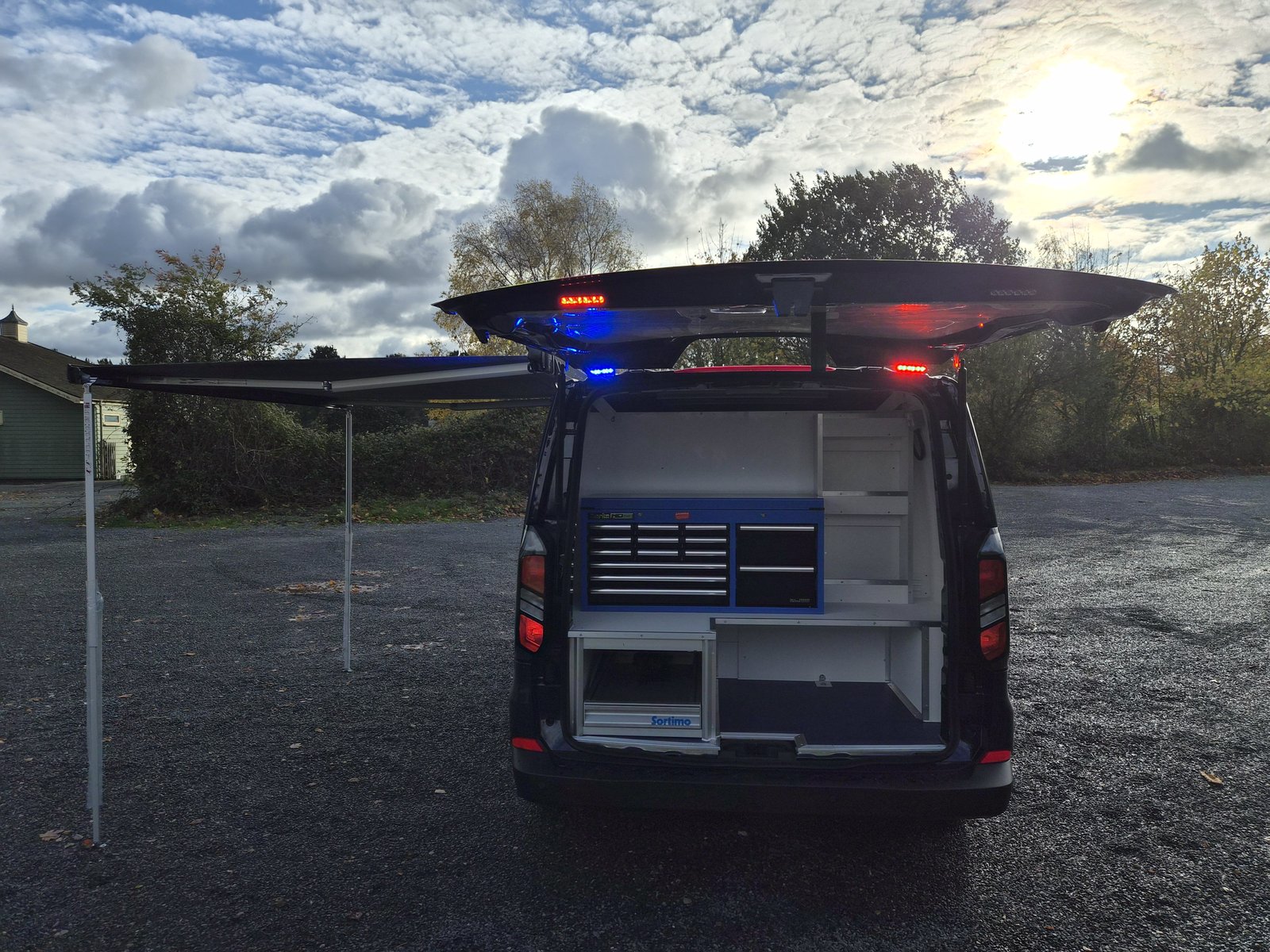 Police Examiner van interior, rear cabinetry with blue and red lights on