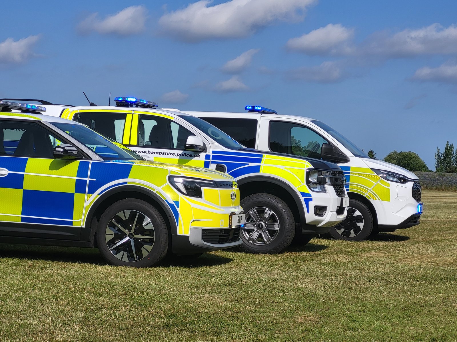 Hampshire Police fleet including cell van, on grass