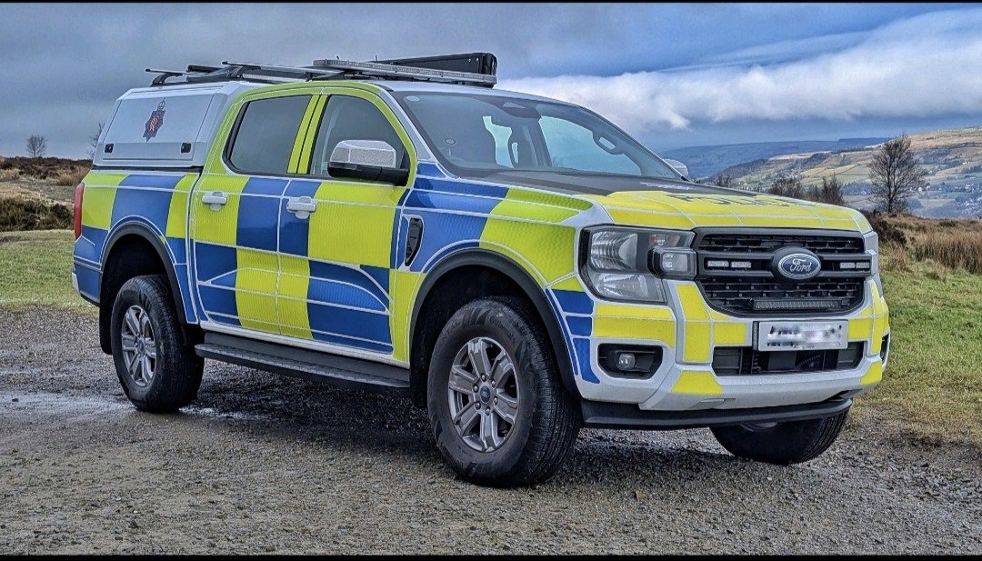 Police Ford Ranger, front three-quarter view with hills backdrop